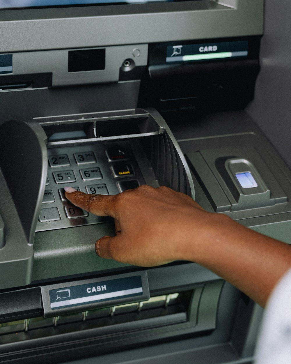 Customer using an ATM keypad